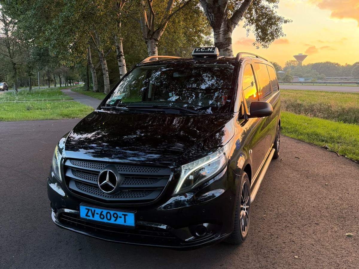 Achtpersoons taxibus van Taxi Centrale Nijmegen met T.C.N.-daklicht bij zonsondergang